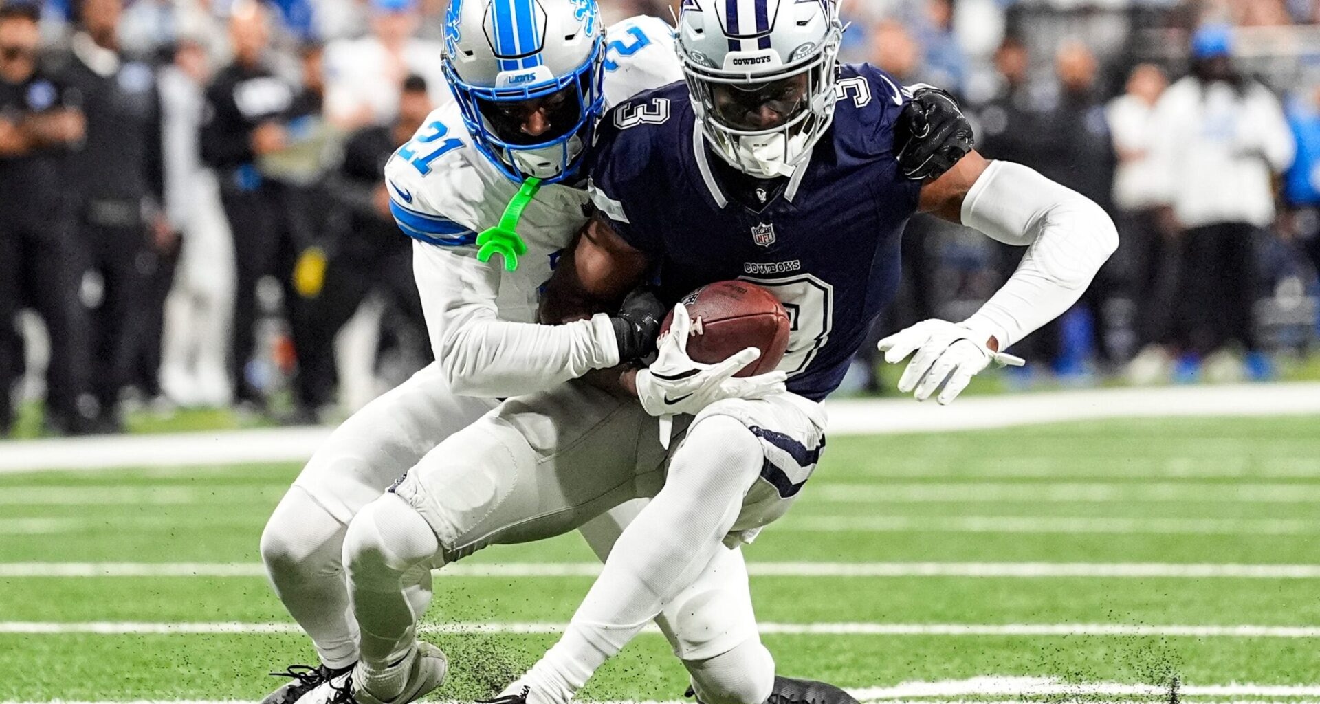 Detroit Lions cornerback Amik Robertson (21) tackles Dallas Cowboys wide receiver George Pickens (3) during the first half at Ford Field in Detroit on Thursday, Dec. 4, 2025.