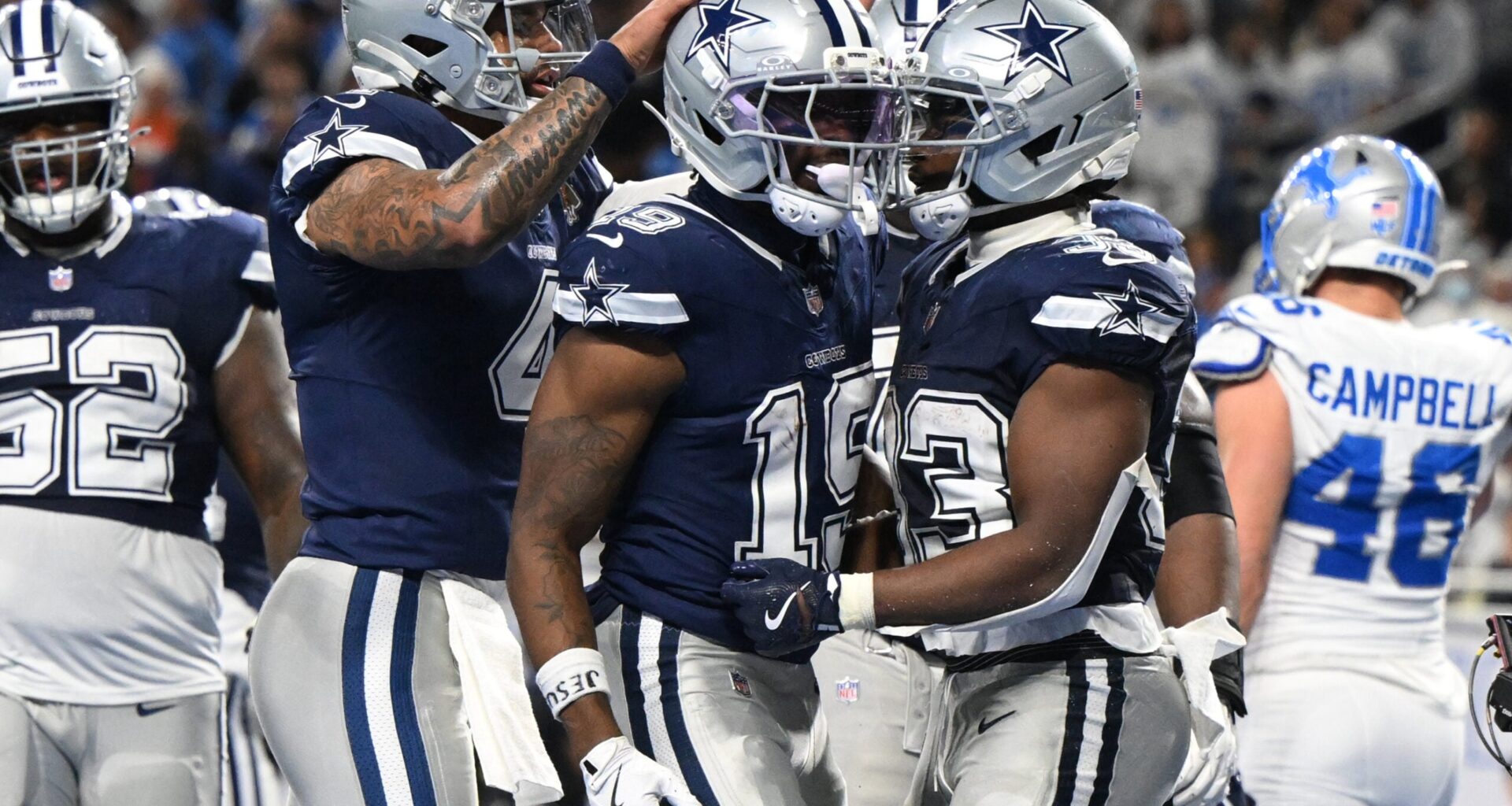 Dec 4, 2025; Detroit, Michigan, USA; Dallas Cowboys running back Javonte Williams (33) celebrates with quarterback Dak Prescott (4) and wide receiver Ryan Flournoy (19) after scoring a touchdown during the second half against the Detroit Lions at Ford Field.