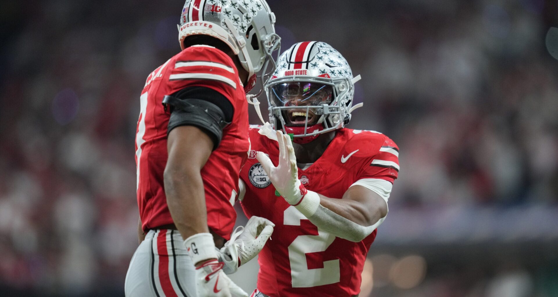 Dec 6, 2025; Indianapolis, IN, USA; Ohio State Buckeyes safety Caleb Downs (2) and cornerback Lorenzo Styles Jr. (3) react in the first half against the Indiana Hoosiers during the 2025 Big Ten championship game at Lucas Oil Stadium.
