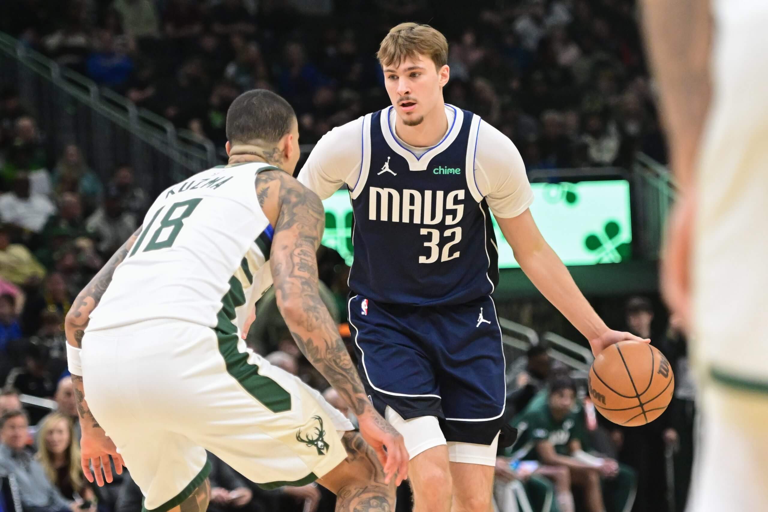 Cooper Flagg dribbles the ball.