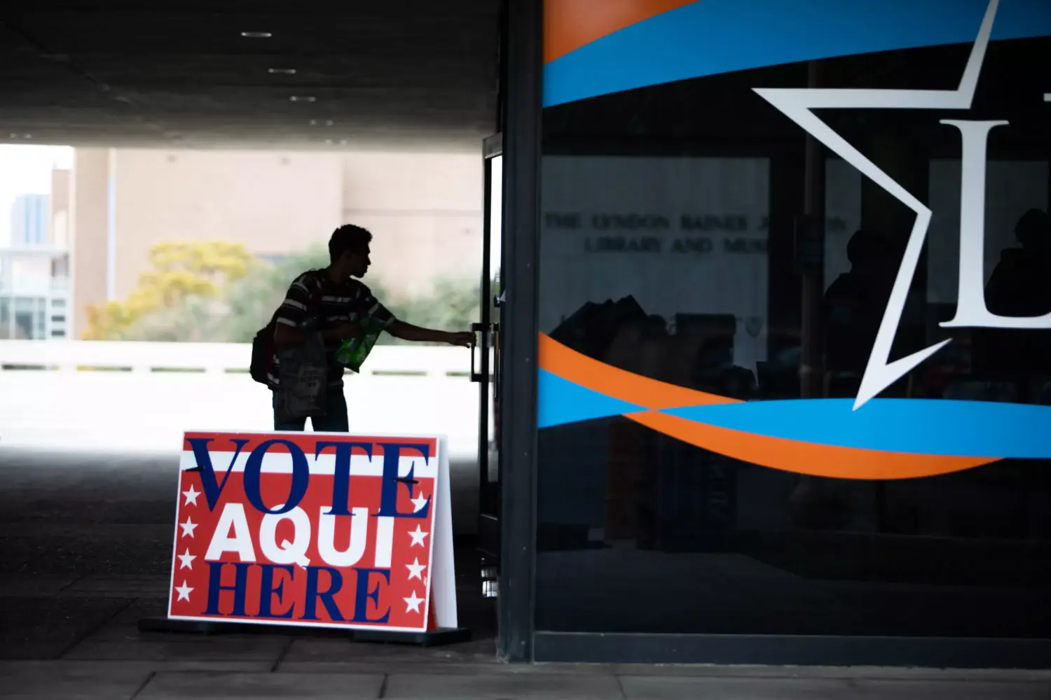 A voter enters a polling location at the Lyndon B. Johnson Presidential Library and Museum during the last day of early voting in Austin, Texas on Nov. 7, 2022.