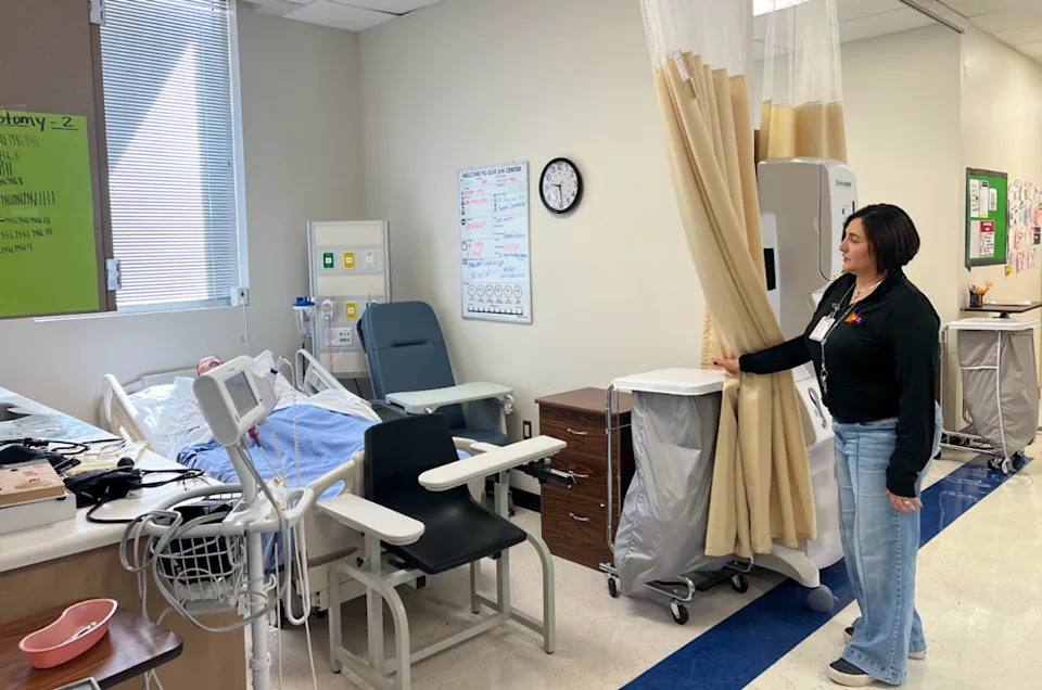 <em>Mary Alice Cantu, director of the Next Generation Medical Academy, shows a model hospital bed that students use in class at Freer High School. (Lauren Wagner)</em>