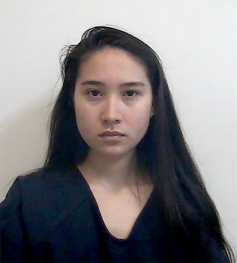 Mugshot of a young woman with long dark hair.