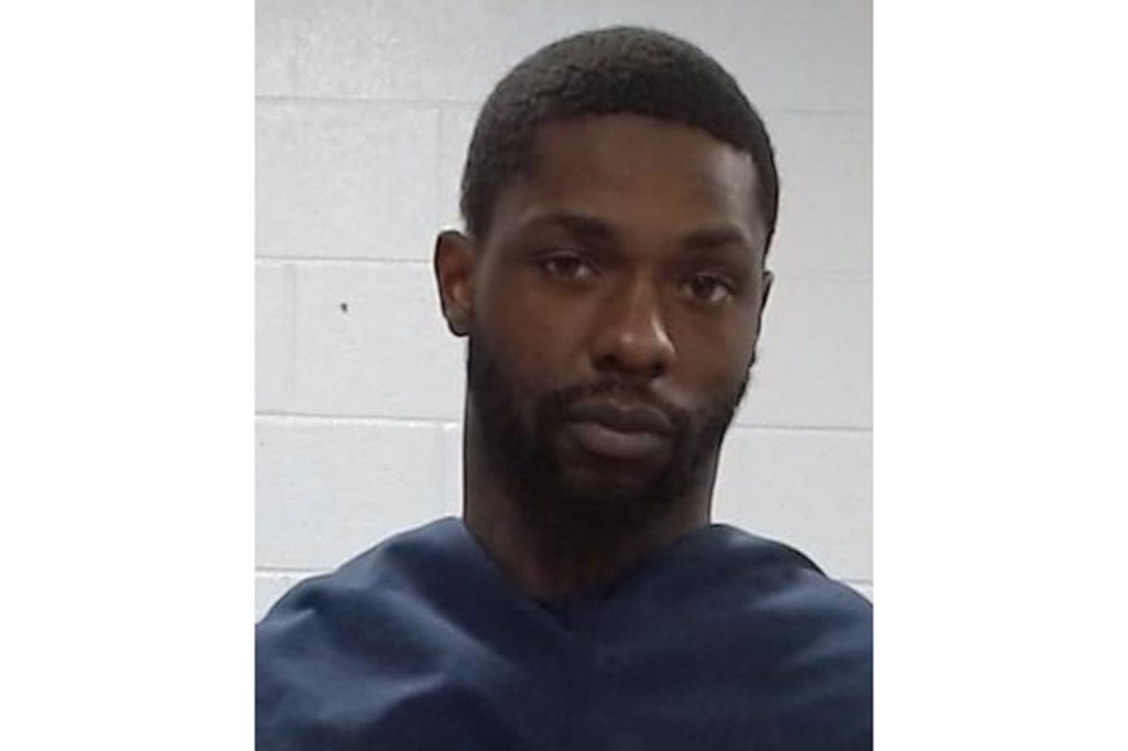 Mugshot of Markquese Bell, a man with a dark complexion, black hair, and a short beard, wearing a dark blue shirt.