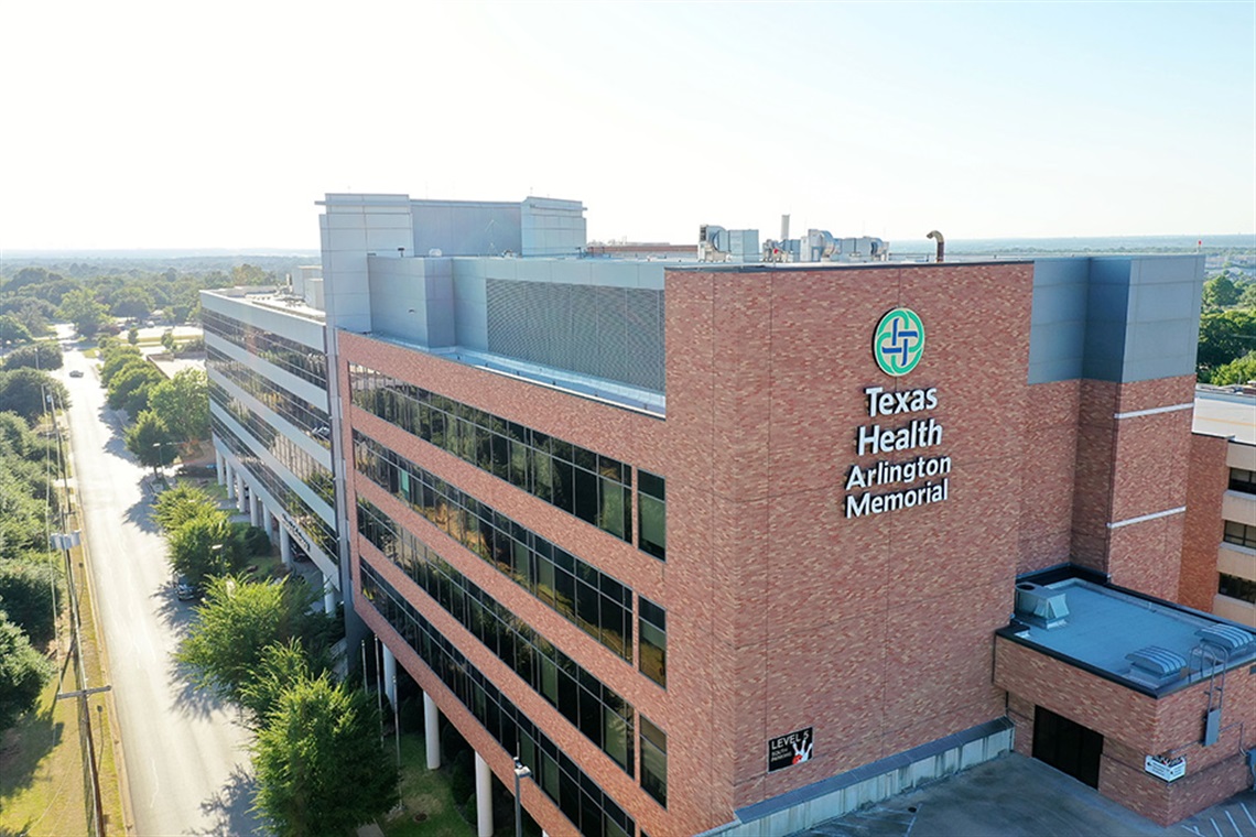 Aerial exterior shot of brick building with words 