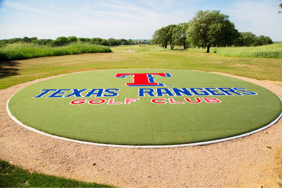 Photo of the Texas Rangers Golf Club logo on the grass outside.