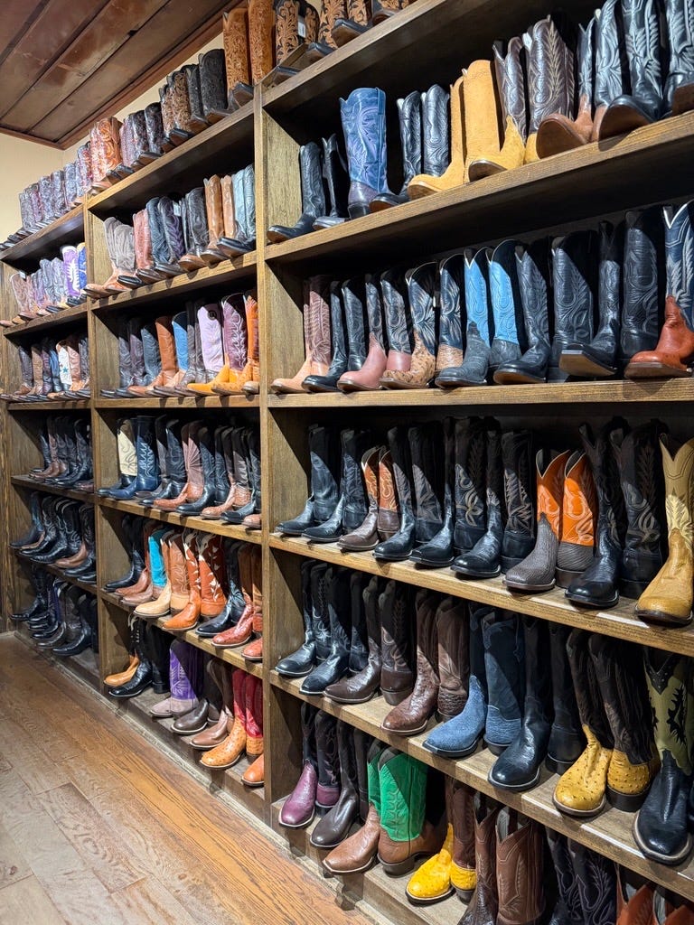Display of various cowboy boots arranged on shelves