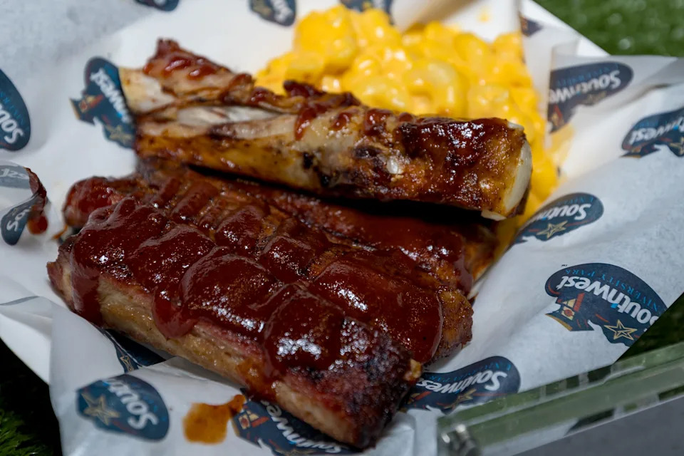 Deep-fried ribs tossed in barbecue sauce and served with macaroni and cheese are prepared during a food tasting event for the El Paso Chihuahuas and El Paso Locomotive FC home games at Southwest University Park on Wednesday, Feb. 25, 2026, in El Paso, Texas.