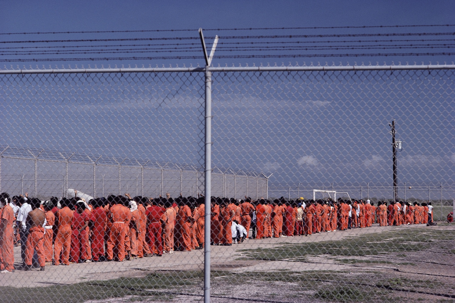 Inmates wear orange jump suits in a holding center for illegal immigrants in Brownsville, Texas. The men are all OTMs ("Other Than Mexicans") who have entered the United States through Mexico.
