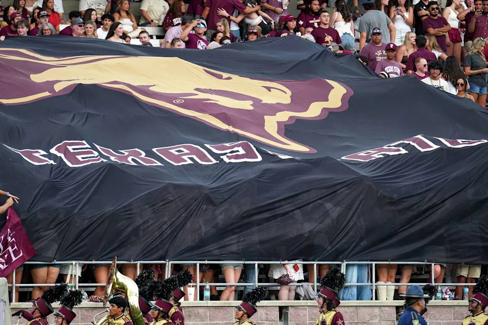 Texas State fans hold a university logo flag during the game against Nicholls State at Texas State University on Saturday, Sep. 20, 2025 in San Marcos, Texas. (Aaron E. Martinez/Austin American-Statesman)
