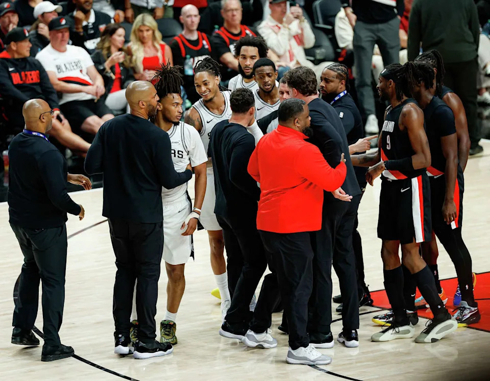 Players and staff swarm the court after a fight broke out between Portland Trail Blazers forward Deni Avdija (8) and San Antonio Spurs guard Stephon Castle (5) during the fourth quarter of Game 4 of a first-round NBA playoff series at Moda Center on Sunday, April 26, 2026. Castle and Avdija both received technical fouls. The Spurs won 114-93, leading the series 3-1.Players (Sam Owens/San Antonio Express-News)