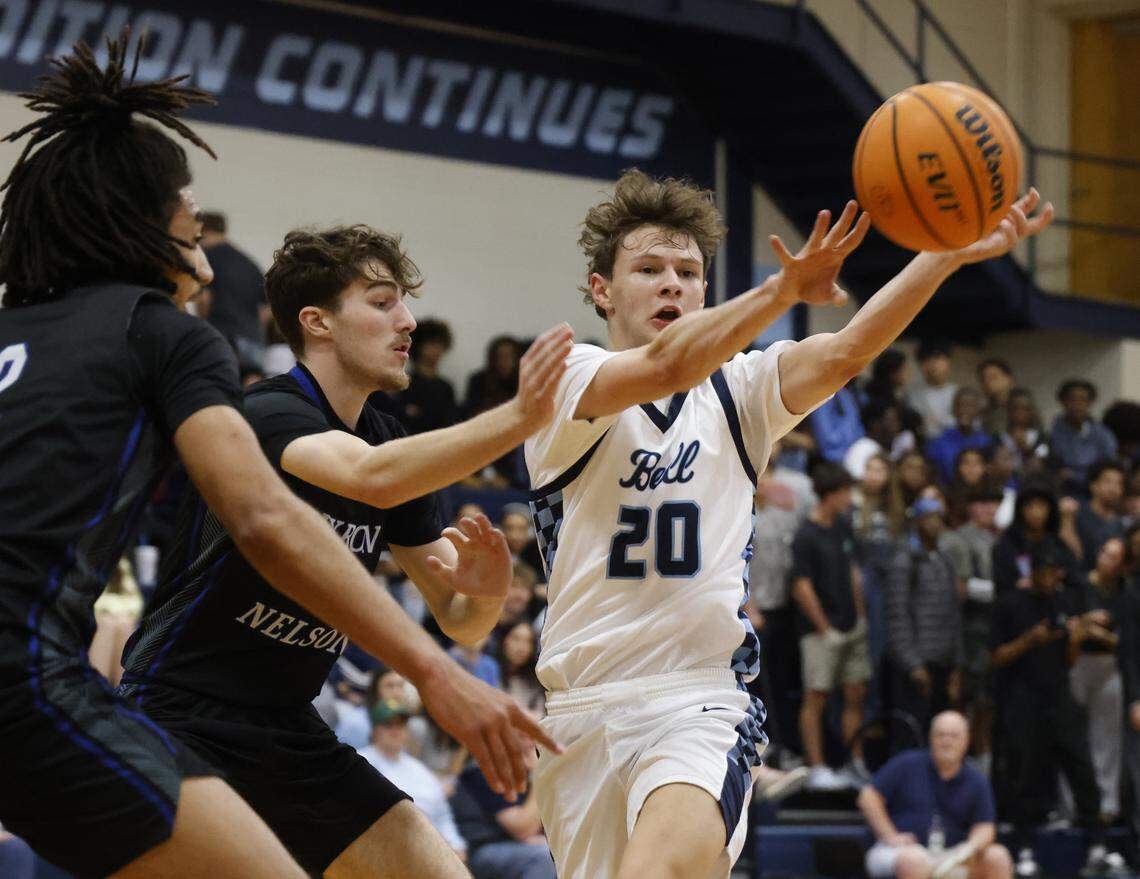Hurst L.D. Bell forward Jesse Mikus (20) passes the ball out of a Trophy Club Byron Nelson double-team during the first half Feb. 6 at L.D. Bell.