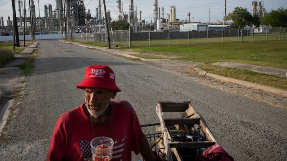 Gavino Rivera talks about the decline of the Hillcrest neighborhood Thursday, Nov. 16, 2023, as he gathers scrap metal near a Citgo oil refinery in Corpus Christi, Texas. (Jon Shapley/Houston Chronicle via AP)