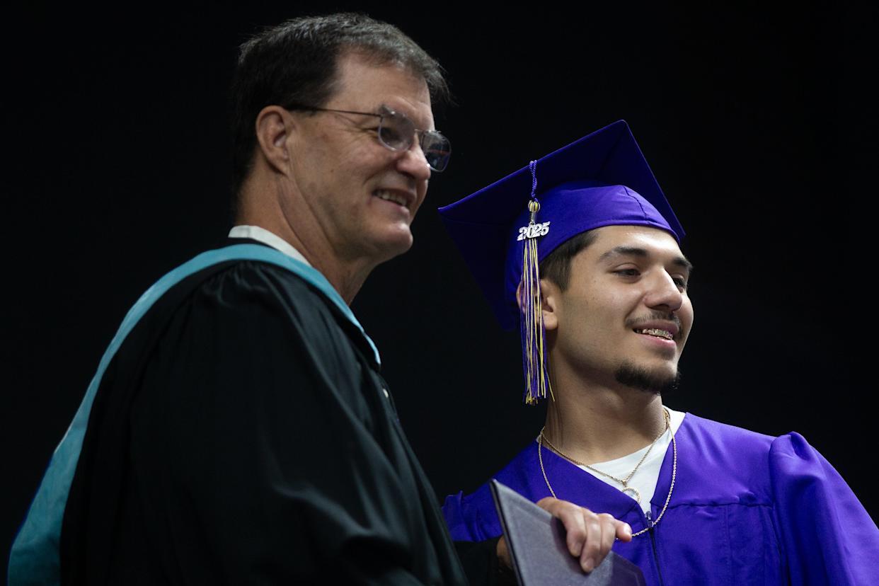 Corpus Christi Independent School District board member Marty Bell, left, poses with a Miller High School graduate during the school's commencement ceremony on May 30, 2025.