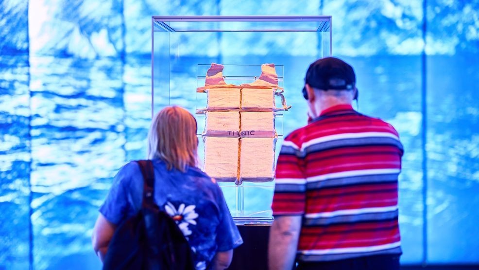 Visitors move quietly through the exhibition, pausing to read the personal stories behind artifacts recovered from the Titanic.