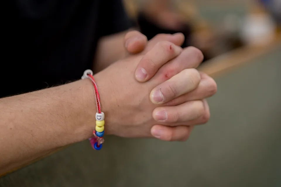 Mason Thompson prays inside Most Holy Trinity Catholic Church on Friday, March 27, 2026, in El Paso, Texas. He wears a bracelet made by his daughters.