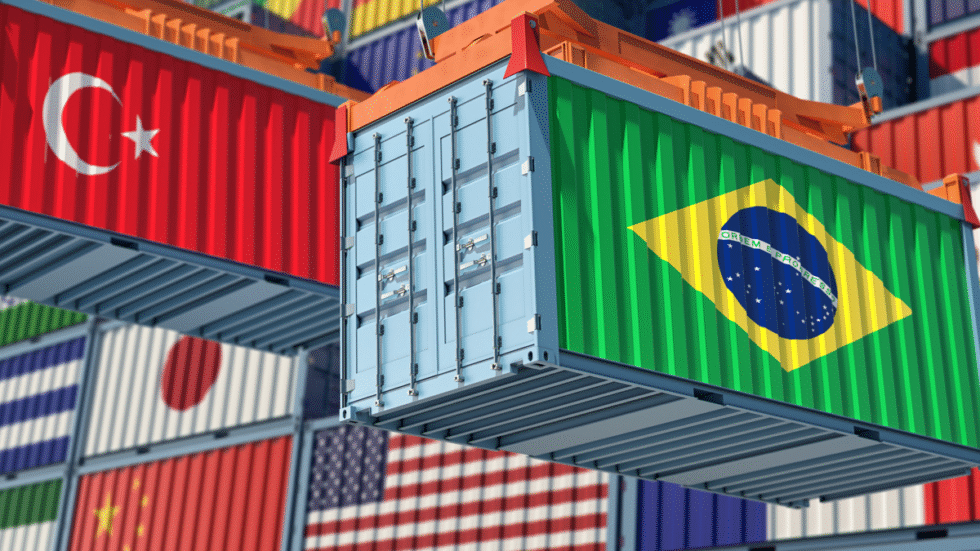 A photographic illustration showing import shipping containers with different country flags.