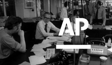 A historical picture of a newsroom from the 1970's with the AP logo in white super imposed.