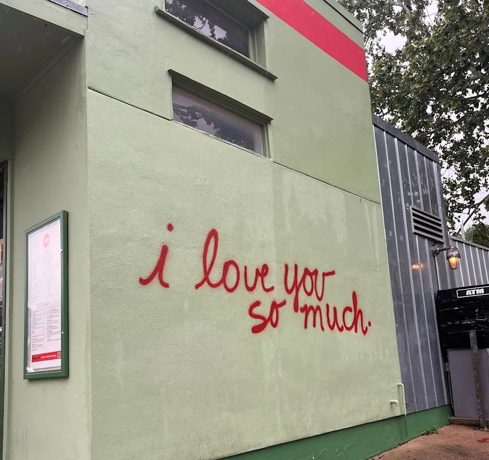 In 2011, musician Amy Cook spray painted the now-iconic "I love you so much" mural in Austin, Texas, outside of popular coffee shop Jo's.