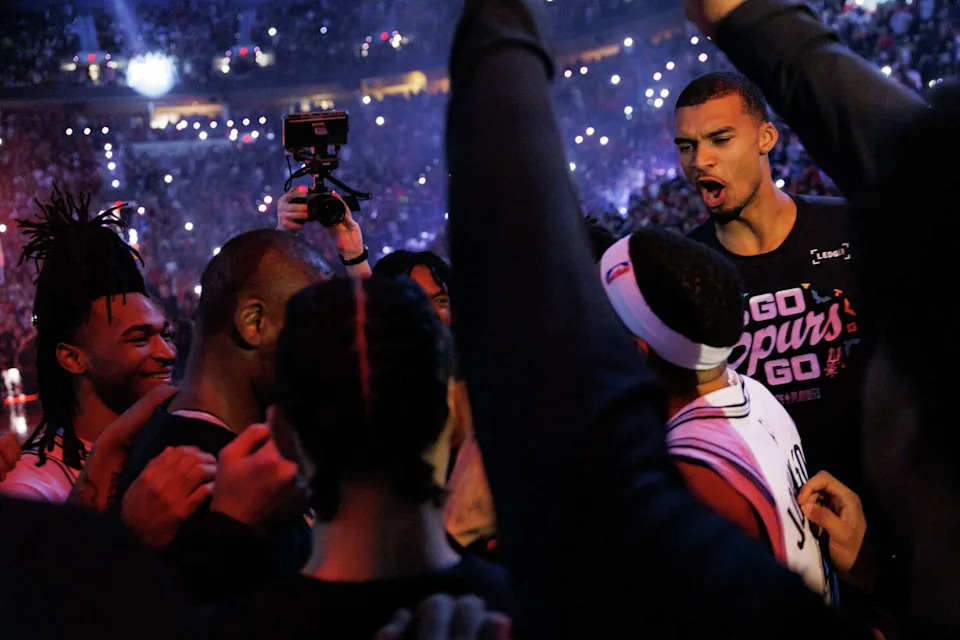 San Antonio Spurs guard Stephon Castle, far left, and San Antonio Spurs forward Victor Wembanyama, far right, cheer with their teammates as they prepare for Game 4 of a first-round NBA playoff series against the Portland Trail Blazers at Moda Center on Sunday, April 26, 2026. (Sam Owens/San Antonio Express-News)