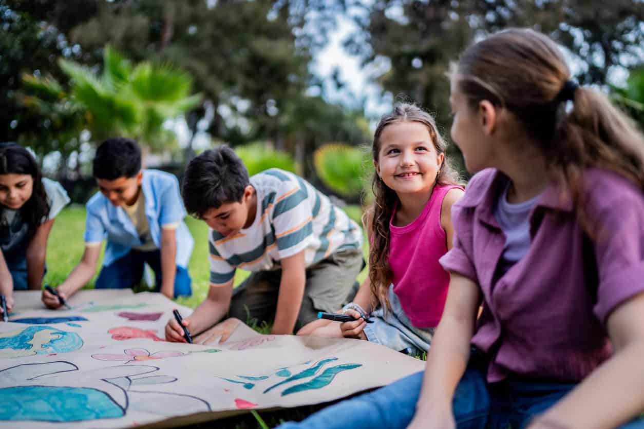 Children participating in outdoor art activities at summer camp in Tarrant County.
