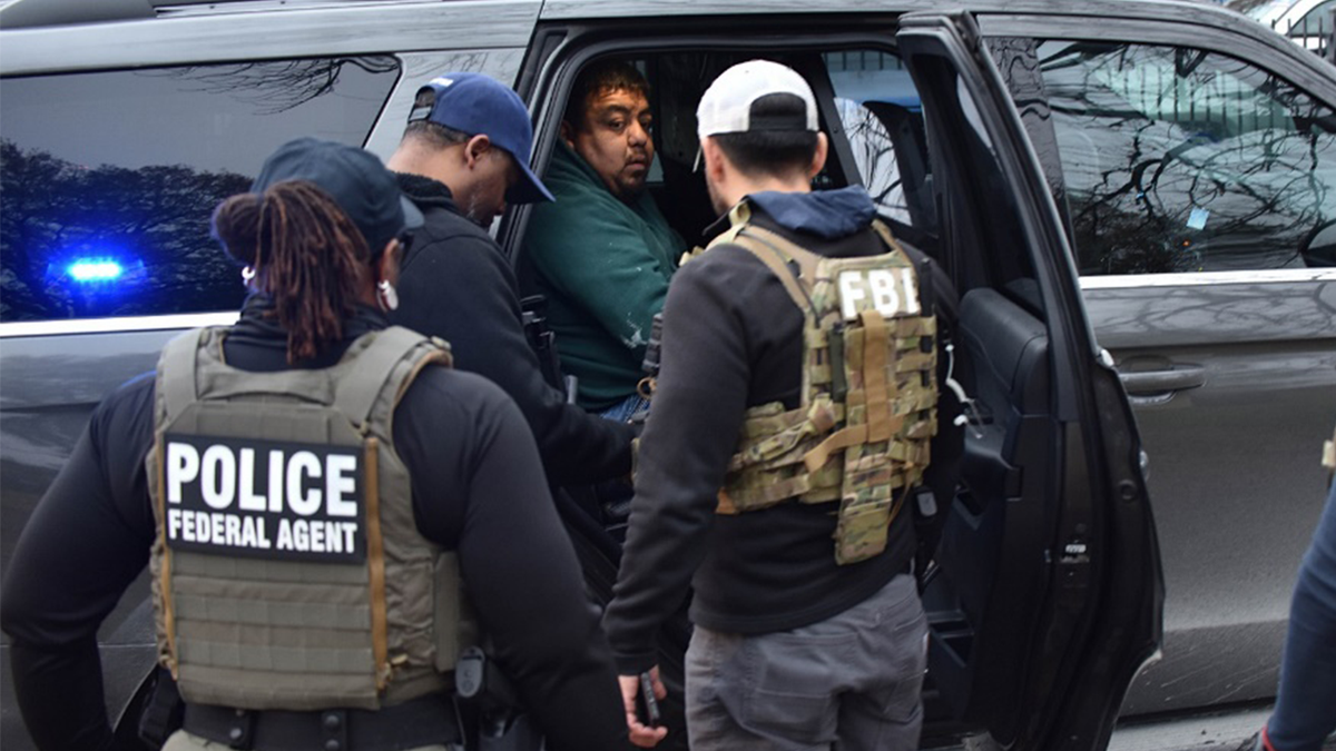 ICE federal law enforcement officers taking a suspect into custody in Houston Texas