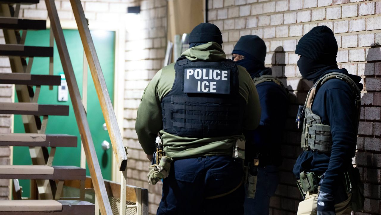U.S. Immigration and Customs Enforcement officers wait to detain a person, Monday, Jan. 27, 2025, in Silver Spring, Md. (AP Photo/Alex Brandon, File)