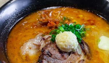 spicy miso ramen in a bowl served with two thick slices of pork belly at Ichigoh.
