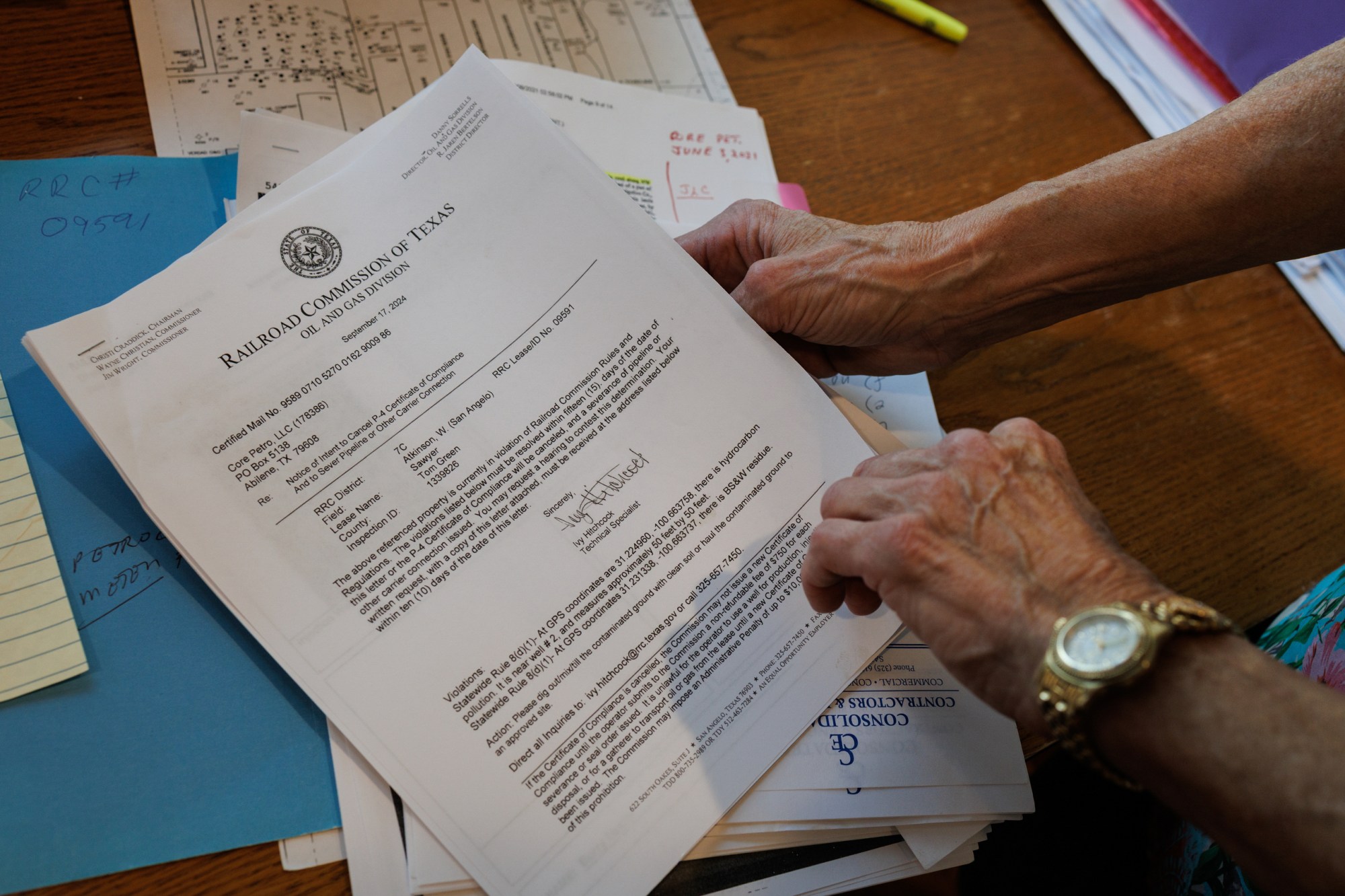 Jackie Lynn Chestnutt looks through documents pertaining to oil wells located on her property, many of which are leaking, and not in use anymore, at her home in Knickerbocker, Texas on Tuesday, November 18, 2025. Chesnutt has fought to rehabilitate her property southwest of San Angelo for years, after discovering numerous leaking oil wells that do not produce anymore.