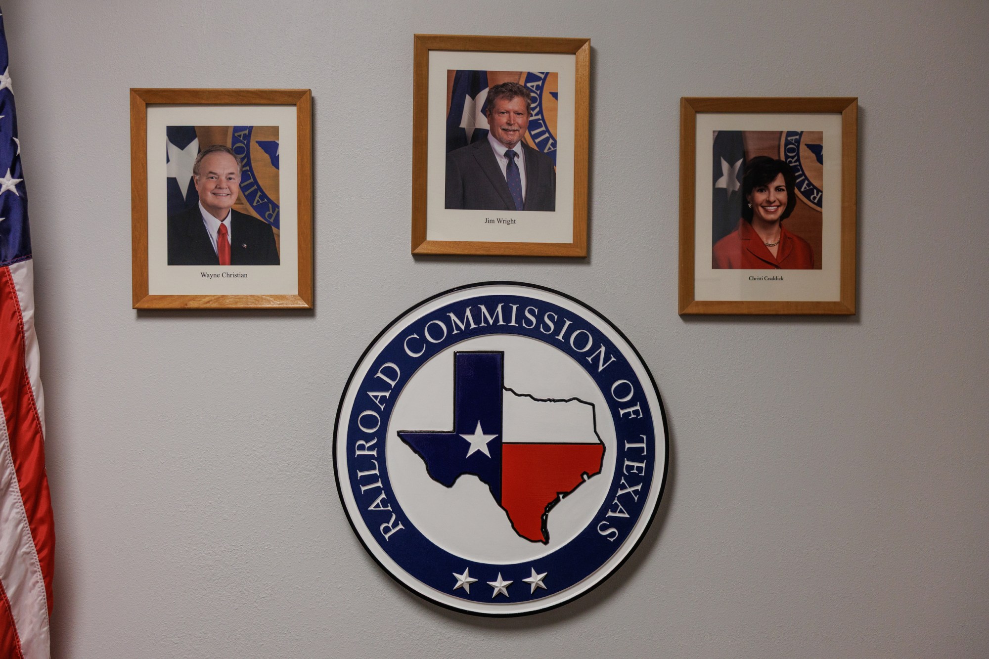 Pictures of the three members of the Railroad Commission of Texas, Wayne Christian, Jim Wright and Christi Craddick, hang in the RRC office in San Angelo, Texas on Wednesday, November 19, 2025.