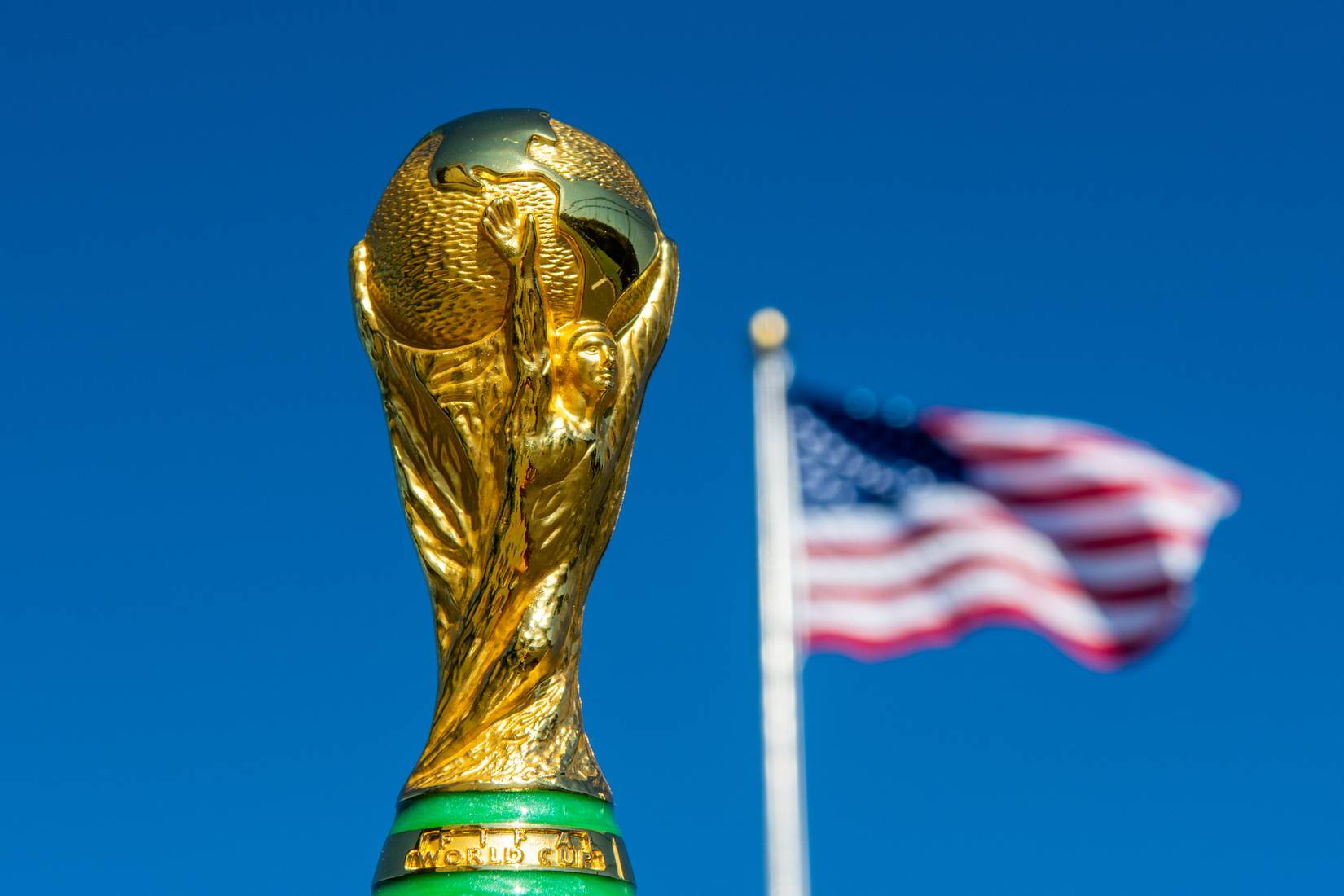 FIFA World Cup trophy with the U.S. flag in the background