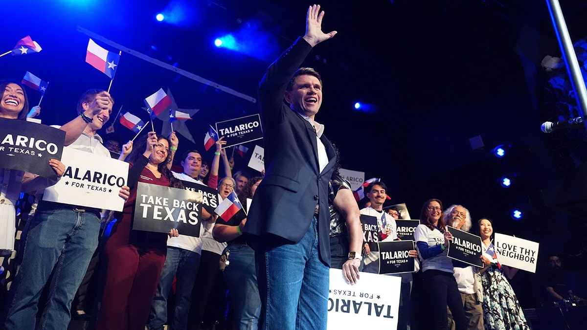 Texas state Rep. James Talarico waving on stage in Austin
