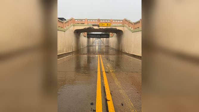 A roadway under a bridge in Texas was closed due to flooding from heavy rain on Sunday.