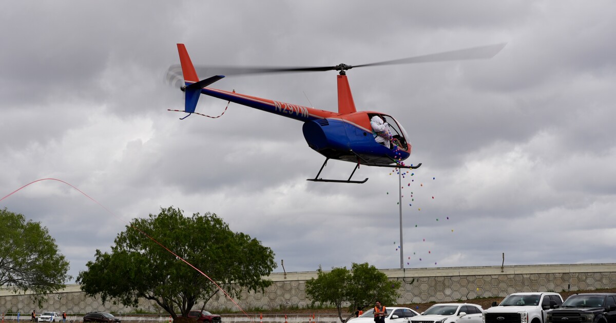 Hundreds of plastic Easter eggs fall from a helicopter at Church of Hope