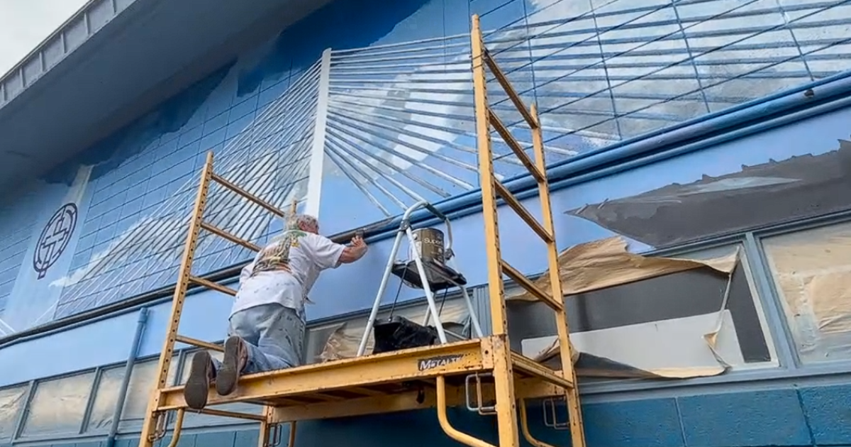 Another harbor bridge is being put together with paint and brushes