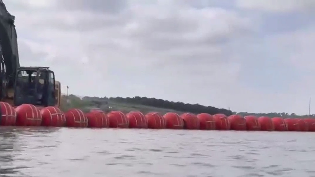 FILE – Floating border barrier in Rio Grande River