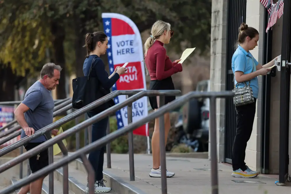 Voters stand in a line to at Oak Lawn Public Library in Dallas.