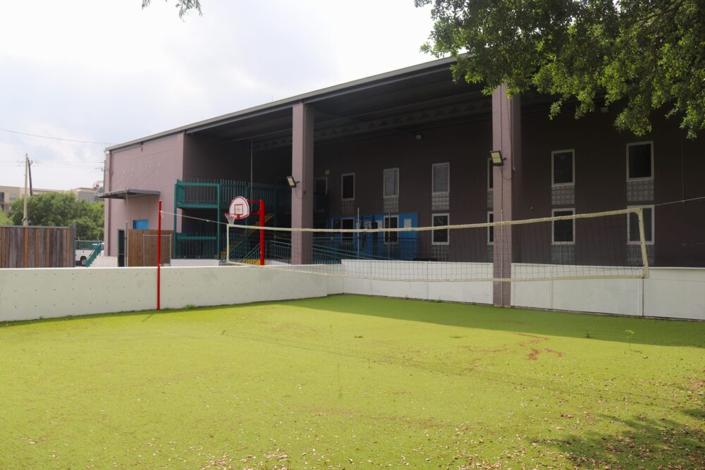 Outside the facility at 419 Emancipation Avenue, a volleyball field and basketball court await residents.