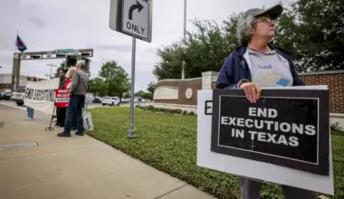 Activists with Dallas Peace and Justice Center hold up signs to abolish the death penalty while the execution of James Broadnax was happening Thursday, April 30, 2026, in Dallas.