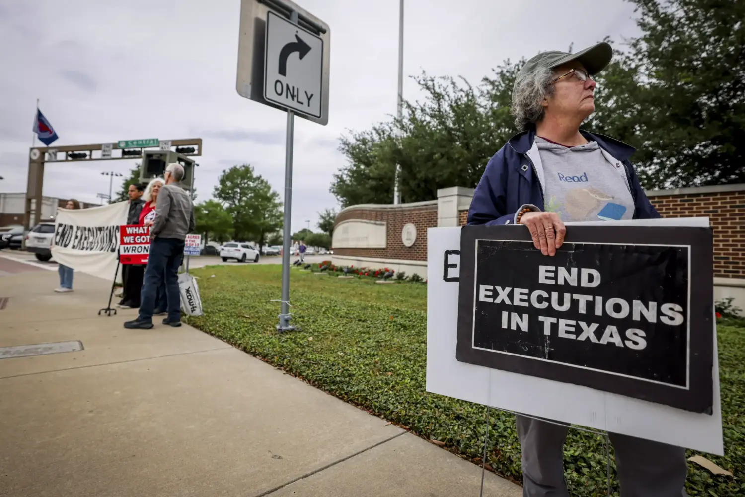 Activists with Dallas Peace and Justice Center hold up signs to abolish the death penalty while the execution of James Broadnax was happening Thursday, April 30, 2026, in Dallas.