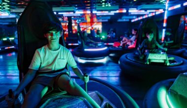 Child enjoying arcade bumper car ride at Pinstack amusement center