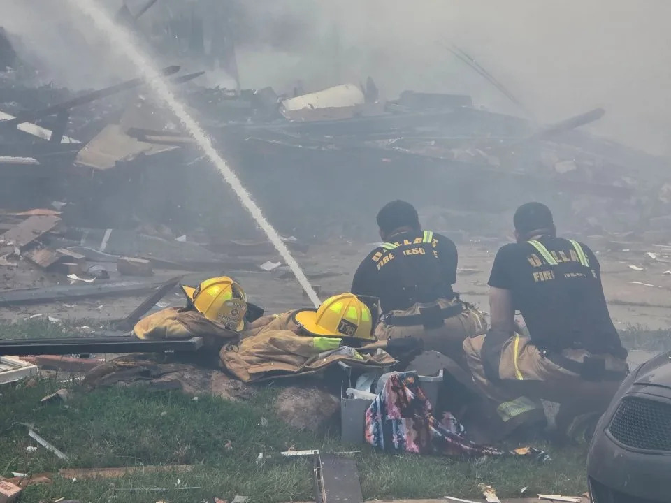 Dallas Fire-Rescue crews search through debris after an apartment explosion and four-alarm fire at 409 E. 9th St. in Dallas on Wednesday. Officials said the fire was under control as the incident remained ongoing. (Dallas Fire-Rescue via X)