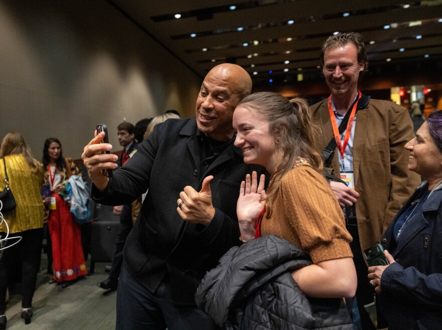 A man takes a selfie with a woman. 