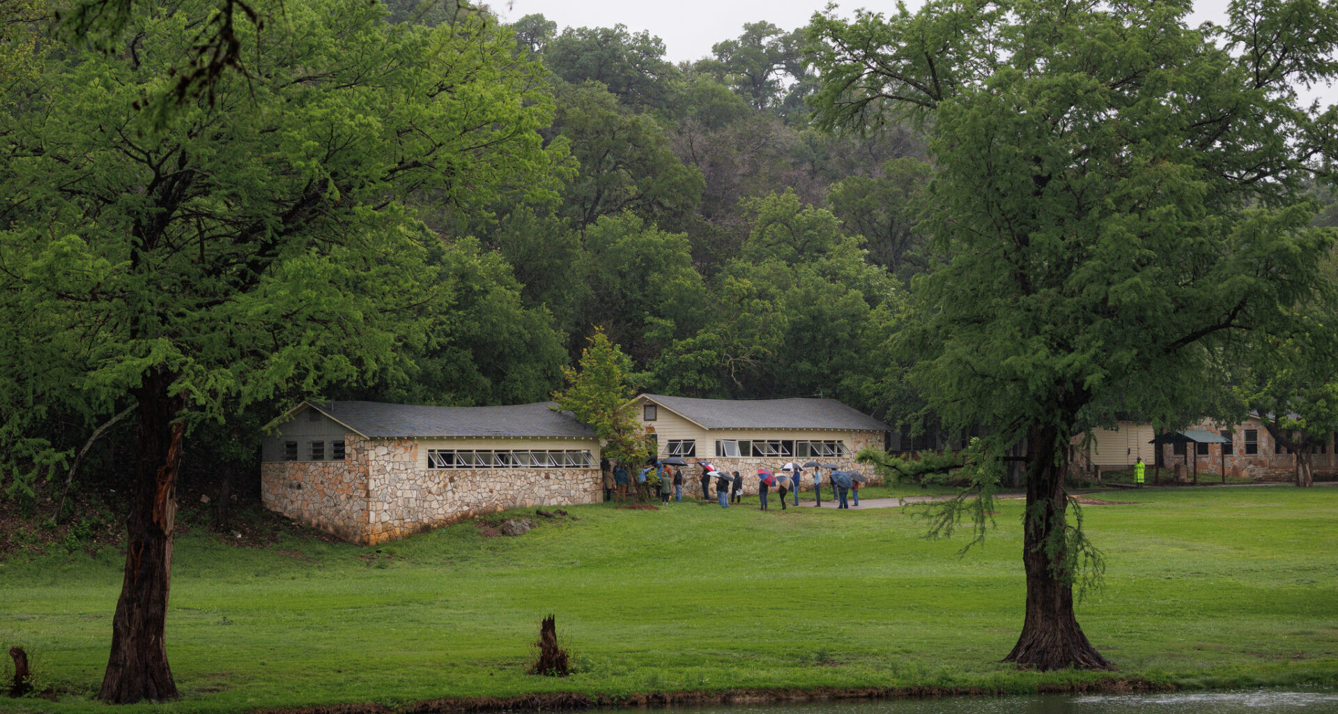 State lawmakers serving on a joint general investigating committee examining the July 2025 flooding walk the grounds of Camp Mystic in Hunt, Texas, on April 20.