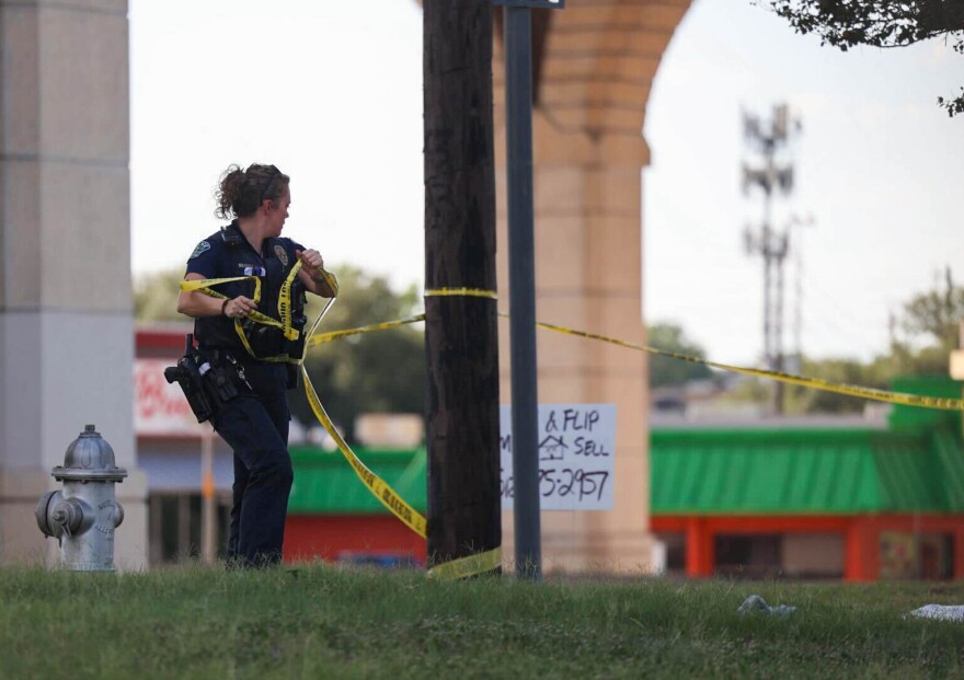 Austin Police officers respond to a shooting in the parking lot of a Target at 8601 Research Boulevard in North Austin on Monday, August, 11, 2025. Three people died in the shooting and the suspect is in custody according to APD officials. Lorianne Willett/KUT News
