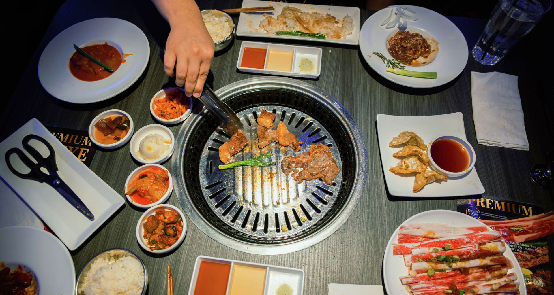A spread of dishes and the tabletop grill at Gen Korean BBQ House.