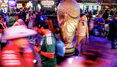 Fort Worth resident Federico Robles, 34, takes a photo with the World Cup trophy statue during the draw watch party on Friday, Dec. 5, 2025, in Fort Worth.