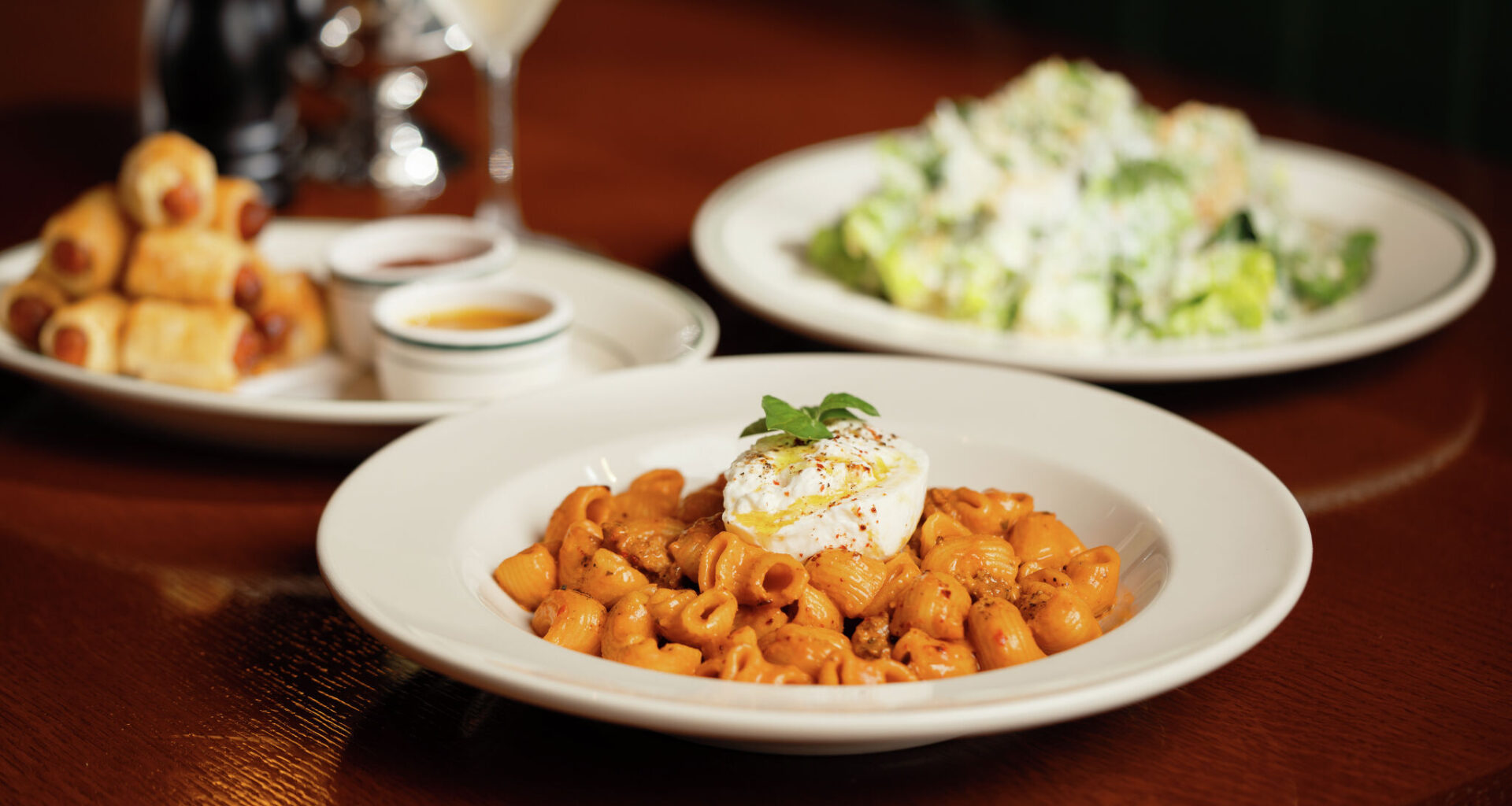 Spicy vodka rigatoni, a caesar salad and pigs in a blanket at the Old City Hall Restaurant and Bar in New Braunfels, Texas. 