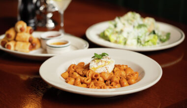 Spicy vodka rigatoni, a caesar salad and pigs in a blanket at the Old City Hall Restaurant and Bar in New Braunfels, Texas. 