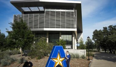 Students pose for photos on the campus of the University of Texas at Arlington on April 19, 2026.